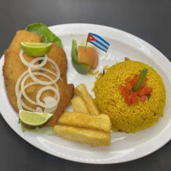 Breaded tilapia with yellow rice and fried yuca